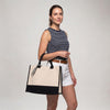 Model carrying the Boutique Canvas Tote with black trim on her forearm