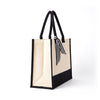 Angled view of the Boutique Canvas Tote with black trim and upright handles