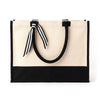 Front view of the Boutique Canvas Tote with black trim and handles resting against the bag