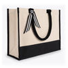 Angled view of the Boutique Canvas Tote with black trim and handles down