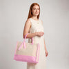 Model carrying the Boutique Canvas Tote with pink trim over her shoulder