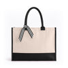 Front view of the Boutique Canvas Tote with black handles, trim and striped ribbon