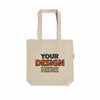 Natural cotton canvas tote bag featuring colorful embroidered "Your Design Here" lettering, showcasing custom logo embroidery services.